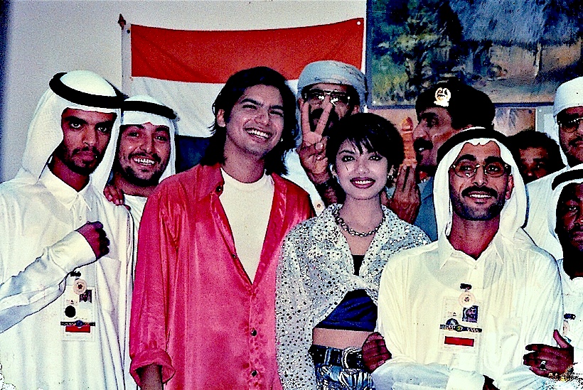 Magnasound artists photographed with Emirati hosts in front of the Indian flag.