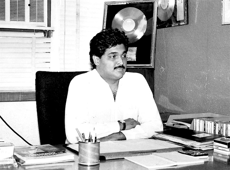 At the desk, with a gold disc