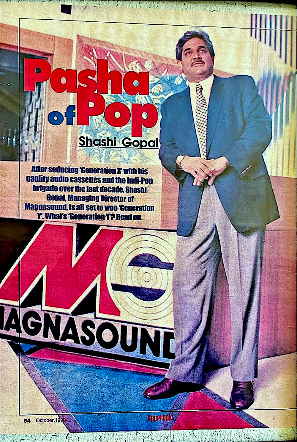 A framed magazine page: &lsquo;Pasha of Pop &mdash; Shashi Gopal&rsquo;, RagaRock, October 1999. He stands on a giant Magnasound floor graphic.